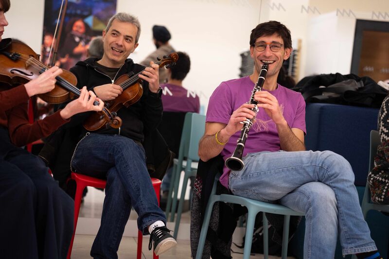 Adults participating in a music workshop