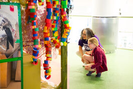 A woman and a child look at artwork