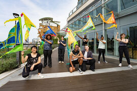 A group of people holding colourful flags