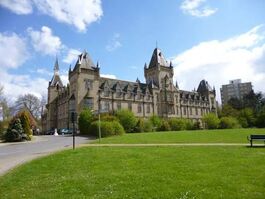 Shows the exterior of the Royal Victoria Patriotic Building on a Sunny day in Wandsworth