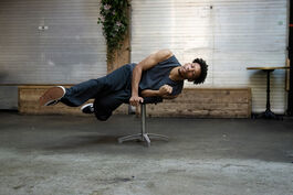Dancer hovers horizontally on a stall 
