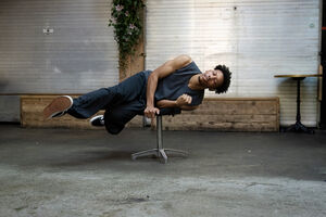 Dancer hovers horizontally on a stall 