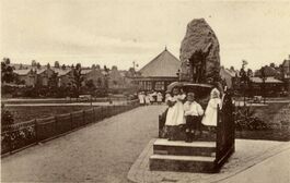 Postcard photographic image showing children playing at the fountain. From Wandsworth Libraries & Heritage Service.
