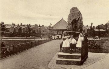 Postcard photographic image showing children playing at the fountain. From Wandsworth Libraries & Heritage Service.