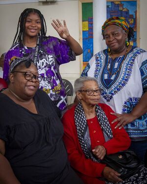 young person with elders waving