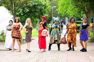 5 women stand in fashion wrapping clothes in York Garden
