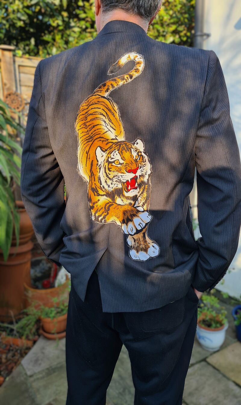 A second hand mans jacket appliqued with a cut out tiger motif from an old shirt