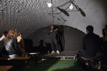 A performer on stage inside an arch