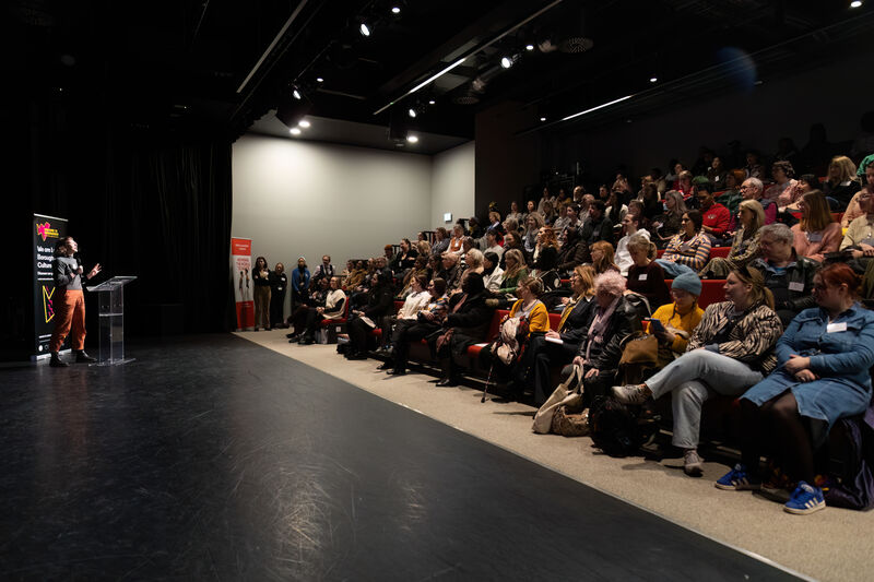 Over 100 audience sitting in the Royal Academy of Dance lecture theatre