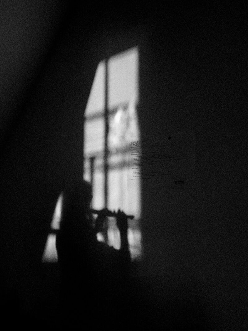 Black and white photo of a recorder player's shadow.