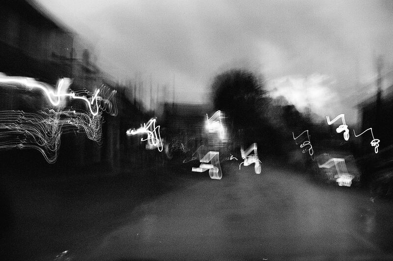 Black and white photo of lights in the distance.