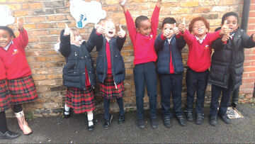 school children cheering, red uniform