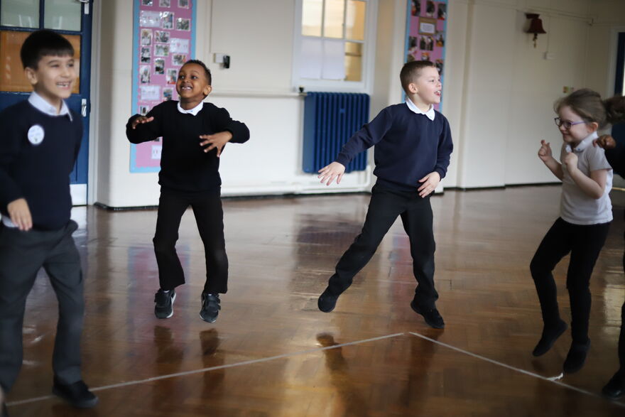 children jumping in school gym