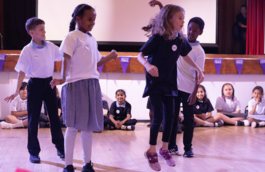 four children performing a drama piece