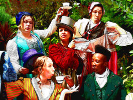 Five actors in Regency outfits swapping costumes and props in a madcap manner