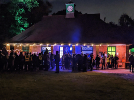 A picture of crowds in front of the Woodfield Pavilion at night