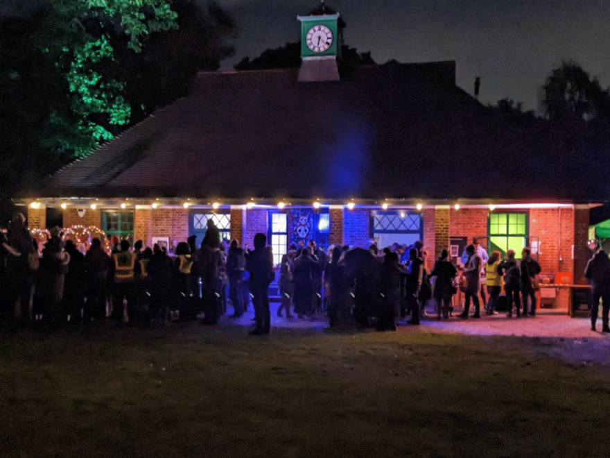A picture of crowds in front of the Woodfield Pavilion at night