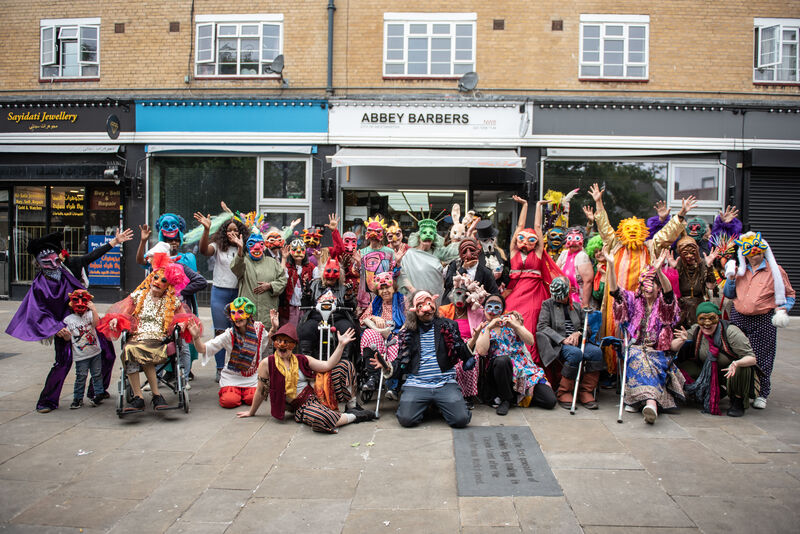 Masked participants posing together in The Church Street Masquerade 2024
