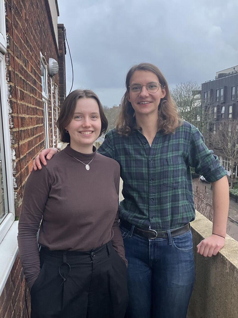 Sofia Swenson-Wright and Lizzie Knatt standing on a balcony.