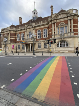 Image shows Battersea Arts Centre with rainbow road crossing in front