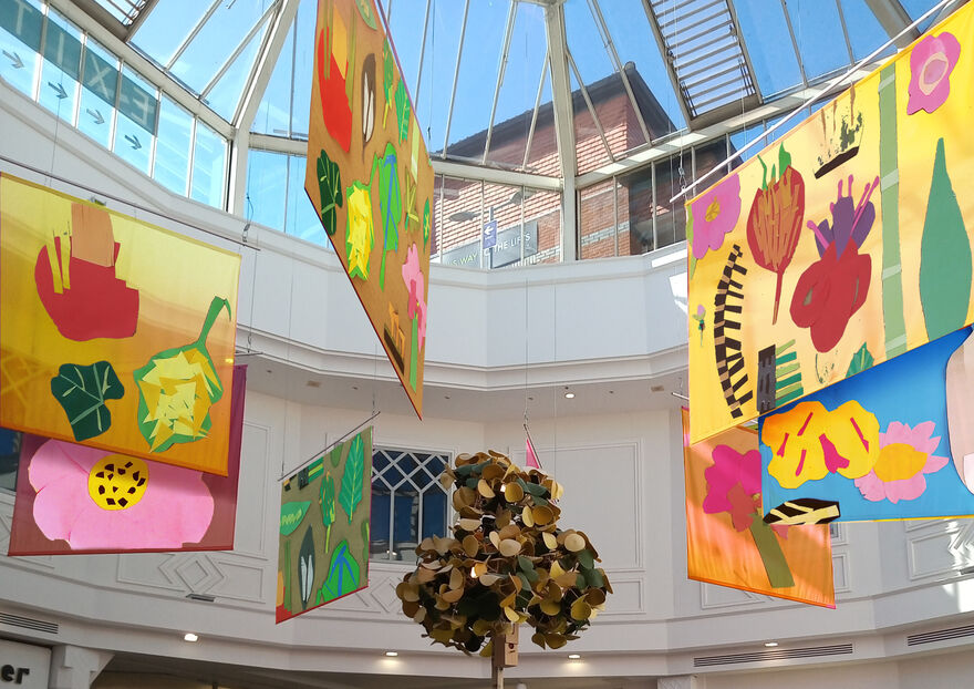 Colourful banners hanging from ceiling in shopping centre
