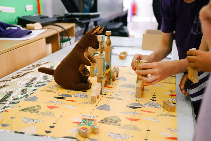 Toy kangaroo and building blocks on colourful paper