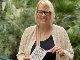 Kate is standing in a peaceful little square in Rome, ready to place one of her POETRY in MOTION postcards on a bench. 