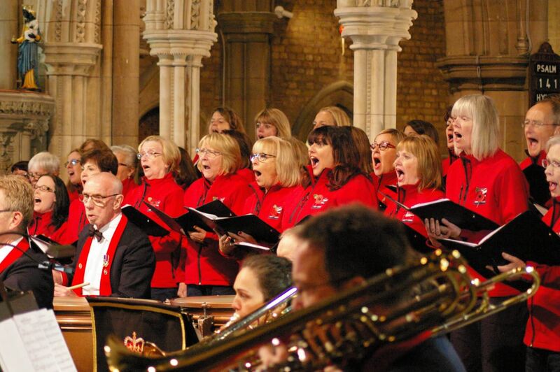 The choir singing with brass accompaniment
