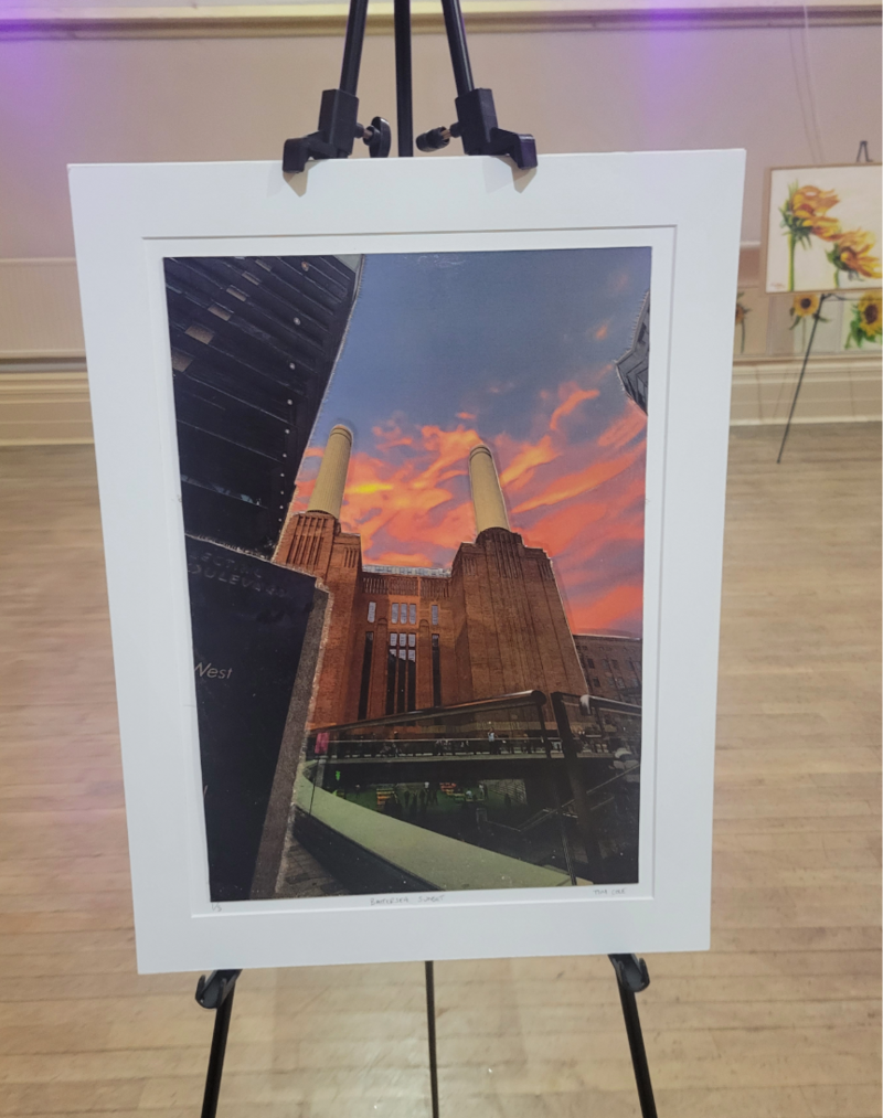 A leather artwork piece based on a front angle view of battersea powerstation sunset with a white border 