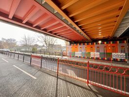 Vibrant and colourful artwork under a bridge one a bright day.