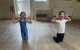 Boy and girl kneeling at the start of their 'Clown' amalgamation