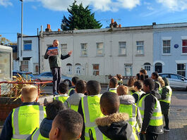 On an educational Walk, Geoff tells Wandsworth schoolchildren about Sadie Crawford's plaque