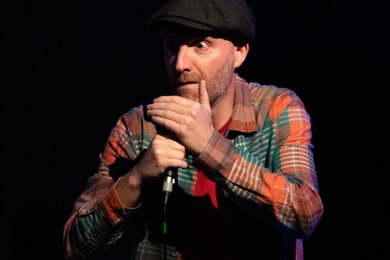 Storyteller at a stand up mic