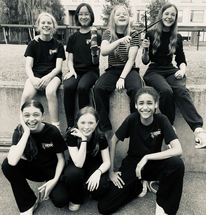 A Black And White Image Of Young Female Musicians Smiling With Instruments