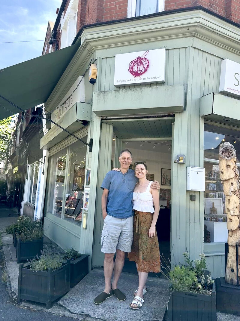 Father and daughter, Crispin and Esme sitting, in conversation, outside Sprout art gallery