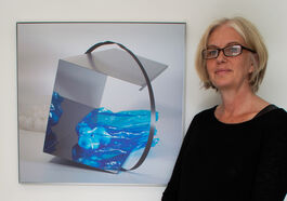 artist standing beside fine art photography