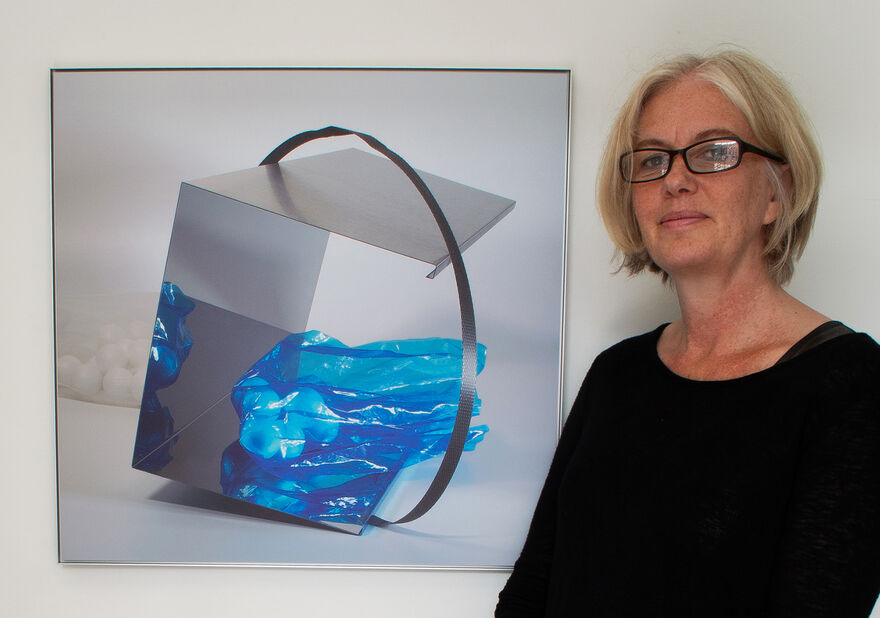 artist standing beside fine art photography